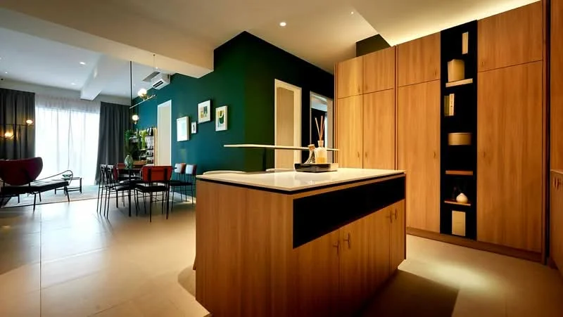 Kitchen features: kitchen island with white countertop, wood cabinetry with black accents, built-in shelves with decorative items, pendant lighting above island, tile flooring, green accent wall, recessed downlights, open layout to dining area; style: modern. Dining features: 6-seater dining table, upholstered dining chairs, floor-to-ceiling windows, curtains, decorative wall art; style: modern.