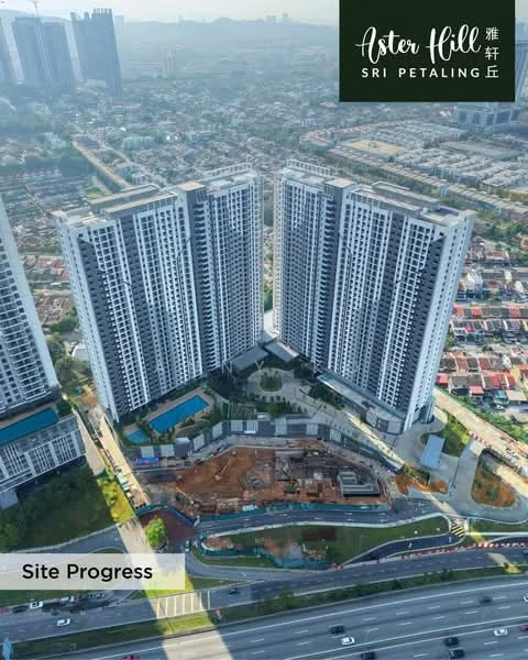 Exterior type: high-rise condominium; features: three high-rise towers, swimming pool, landscaped garden area, construction site visible, surrounding urban area, highway adjacent, manicured lawn, parking area, modern architectural design, glass facade, balconies on each tower, city skyline in background; style: modern.