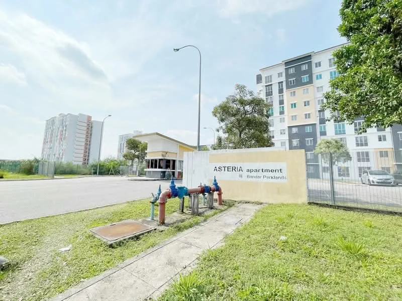 Exterior type: low-rise apartment block; features: signage with 'ASTERIA apartment', landscaped green area, fire hydrants, paved driveway, surrounding grass, multiple storeys, residential buildings in background; style: modern.