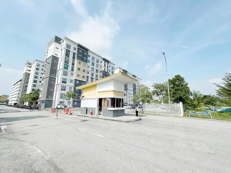 Exterior type: mid-rise condominium; features: yellow and white guard house, surrounding greenery, multiple-storey building, modern facade with mixed materials, parking area visible, street view, paved road, security gate, landscaped area; style: modern.