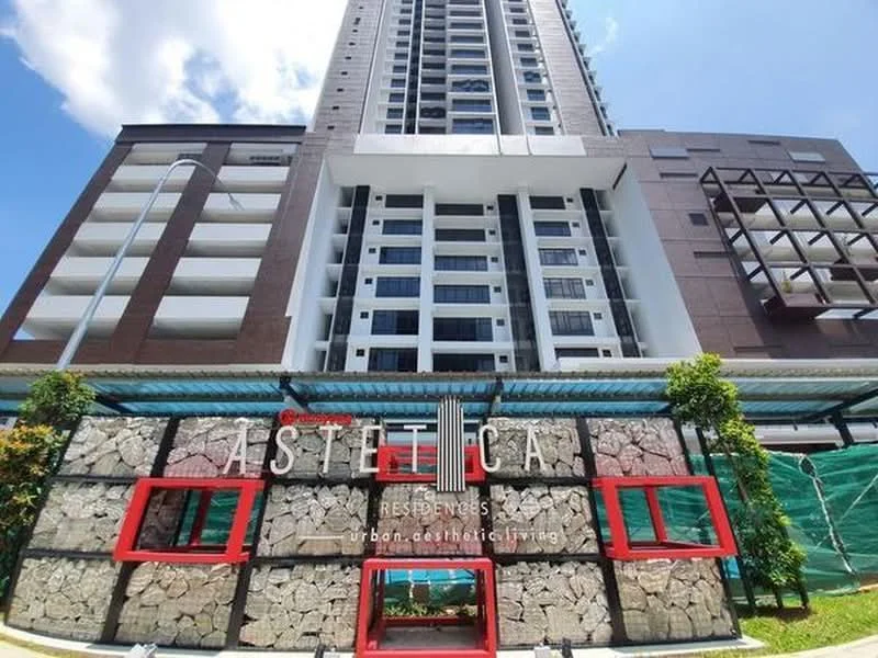Exterior type: high-rise condominium; features: glass curtain wall, exposed concrete facade, red accent frames, stone cladding, covered entrance, landscaped garden area, multiple storeys, balconies on upper floors; style: modern.