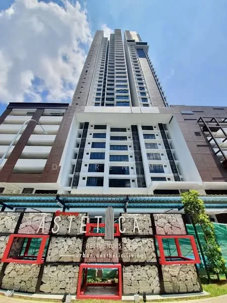 Exterior type: high-rise condominium; features: glass curtain wall, exposed concrete facade, recessed balconies, feature lighting at night, approximately 30-storey high-rise, manicured landscaping, stone cladding at base, red accent windows; style: modern.