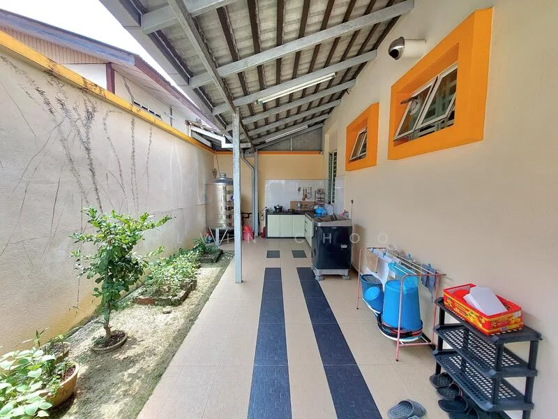 Room features: grey tiled flooring, cream painted walls, metal roof with exposed beams, two windows with orange frames, outdoor kitchen area, sink with countertop, storage shelves, potted plants, small garden area, water tank, refrigerator, plastic storage containers; style: modern; view: garden.