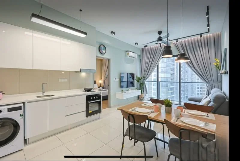 Kitchen features: white cabinetry, black countertop, stainless-steel sink, chrome pull-down faucet, built-in oven, stainless-steel range hood, 4-burner gas hob, washing machine, refrigerator, pendant lighting, tile backsplash, ceramic tile flooring, wall-mounted split AC; style: modern; view: city. Dining features: 6-seater dining table, wooden dining chairs, decorative plant, table setting with plates and cutlery, pendant lighting; style: modern; view: city. Living features: grey fabric sofa, wall-mounted TV, TV console, decorative wall art, floor-to-ceiling windows with curtains; style: modern; view: city.
