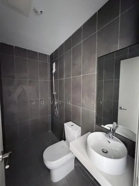 Bathroom features: grey tiled walls, grey tiled flooring, white round basin, chrome faucet, white one-piece toilet, shower with handheld showerhead, mirror above sink, built-in shelf, recessed lighting; style: modern.