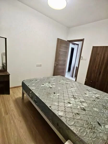 Bedroom features: wooden flooring, white painted walls, single bed with mattress, mirror dresser, wooden door, light fixture on ceiling.