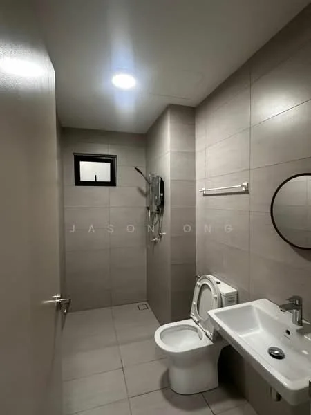 Bathroom features: grey tiled walls, light grey tiled flooring, round mirror, chrome basin mixer faucet, white sink, one-piece toilet, shower with handheld showerhead, wall-mounted shower control, towel rail, small window; style: modern.