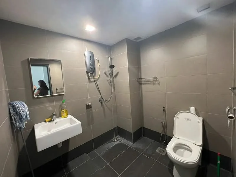 Bathroom features: grey tiled walls, black tiled flooring, single-sink vanity with wall-mounted mirror, chrome basin mixer faucet, toilet, handheld shower, wall-mounted shower head, shower hose, towel rack, soap dispenser, shower drainage, exhaust fan; style: modern.