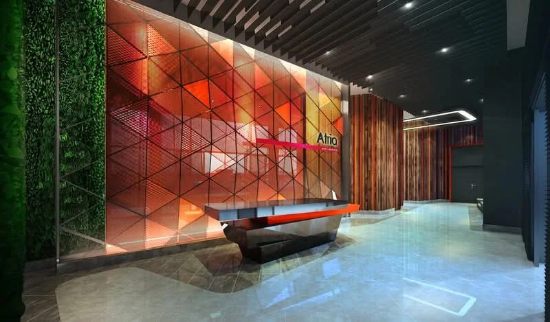 Room features: geometric patterned wall, green wall with plants, illuminated feature wall, reception desk with orange accents, wood paneling, polished stone flooring, recessed lighting, high ceiling with dark beams; style: modern.