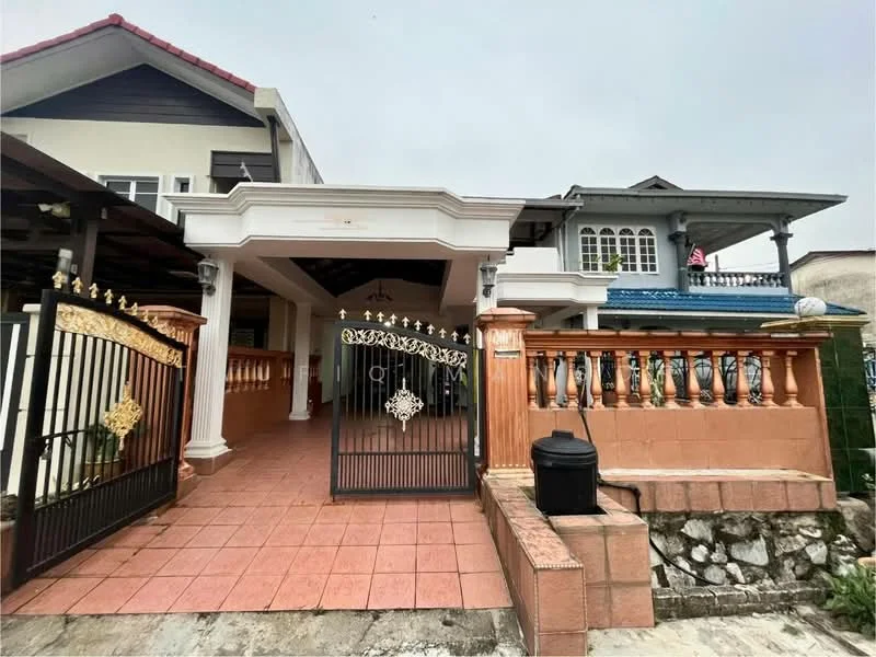 Exterior type: detached bungalow; features: gated entrance with decorative wrought iron gate, brick wall with decorative stone cladding, tiled driveway, covered porch area, roof overhang, balcony with railing, mature landscaping, visible drainage, two-storey structure, front yard area; style: modern.