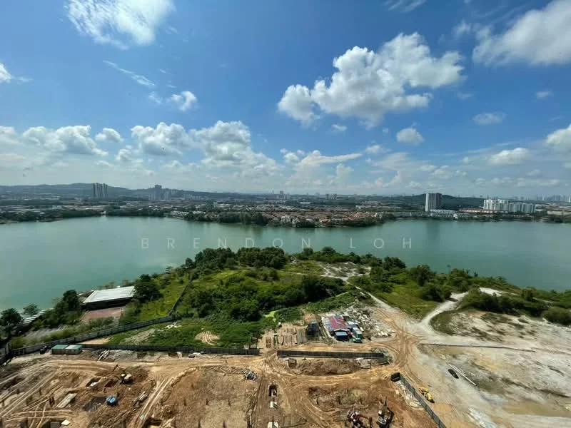 Exterior features: waterfront view, construction site visible, lush greenery, urban skyline in background, cloudy blue sky, hills in distance.