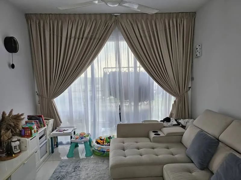 Living features: beige fabric sectional sofa, grey throw pillow, area rug with geometric pattern, floor-to-ceiling windows, sheer curtains, drapes in beige, ceiling fan, decorative wall sconce, white painted walls, wooden flooring, children's play area with colorful toys, small white side table, decorative plants in ceramic pots; style: modern.