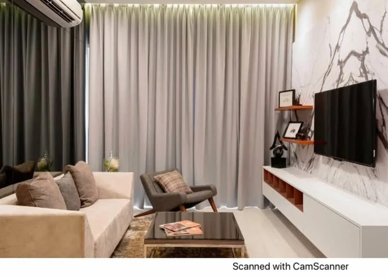 Living features: 3-seater fabric sofa in beige, coffee table with glass top, TV console with storage, wall-mounted TV, decorative wall with marble pattern, floor-to-ceiling curtains in grey, area rug with geometric pattern, accent chair with wooden legs; style: modern.