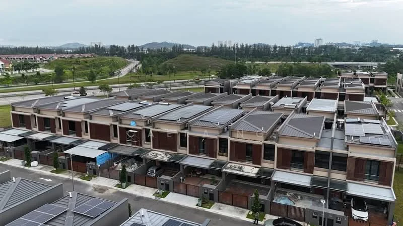 Exterior type: linked terrace house; features: multiple units in a row, solar panels on roofs, flat roof design, brick facade, driveways visible, landscaped greenery in background, surrounded by open space, urban context with nearby road, parking spaces in front of units; style: modern.