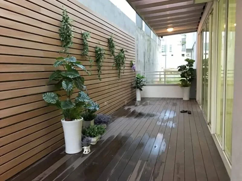 Room features: wooden decking, vertical wooden slat wall, potted plants, ceramic plant pots, outdoor space, sliding glass doors, overhead awning, concrete wall, wet floor; style: modern.