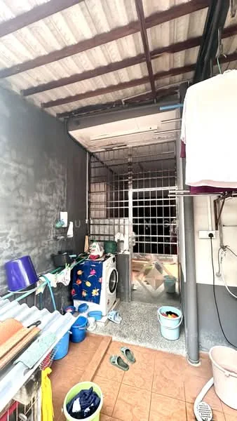 Laundry features: washing machine, grey painted walls, terracotta tile flooring, metal roof, clothes drying rack, plastic storage bins, laundry basket, shelves with cleaning supplies.