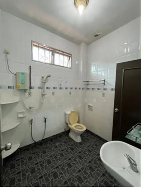 Bathroom features: white tiled walls, grey floor tiles, single-sink vanity with chrome faucet, toilet, shower with handheld showerhead, wall-mounted shower control, window for natural light, built-in shelves, mirror above sink, ceiling light fixture.