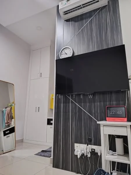 Room features: wall-mounted TV, white side table, digital clock, wall-mounted air conditioning unit, mirrored wardrobe, grey accent wall, light-colored tiled flooring, electrical outlets, shelves, clothing hanging on hooks; style: modern.
