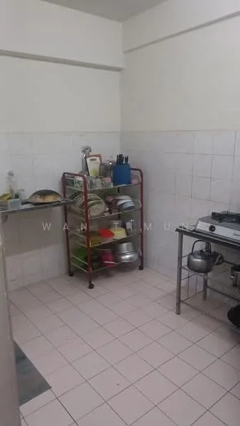 Kitchen features: white tiled walls, light-colored tiled flooring, stainless-steel gas stove, metal shelving unit with plates and pots, sink with faucet, open space layout, window for natural light.