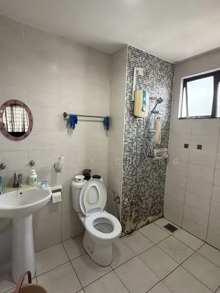 Bathroom features: white ceramic toilet, pedestal sink, chrome basin mixer faucet, shower with handheld showerhead, mosaic tile wall, white tiled walls, white tiled flooring, window for natural light, grab bar, toilet paper holder, soap dispenser.