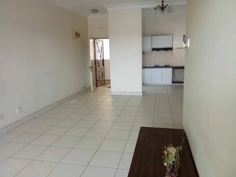 Living features: white painted walls, ceramic tile flooring, ceiling rose, chandelier, open layout to kitchen, large window, neutral color scheme, wall-mounted door, decorative plant on table. Kitchen features: white cabinetry, stainless-steel sink, gas stove, tile backsplash, countertop space, open layout to living area.