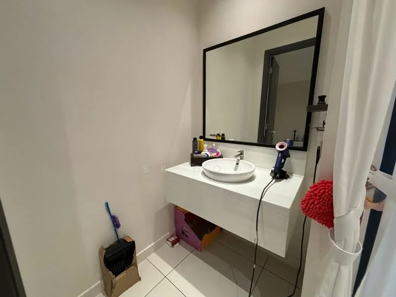 Bathroom features: white wall tiles, light grey painted walls, floating vanity with white cabinet, round white sink, chrome basin mixer faucet, large rectangular mirror, white floor tiles, hairdryer on countertop, cleaning supplies in cardboard box, pink decorative item, black storage box, towel hanging on door; style: modern.
