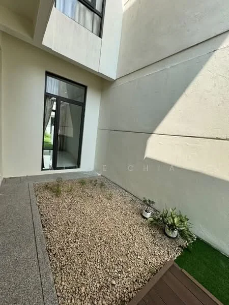 Room features: grey stone flooring, white painted walls, large glass window, small garden area with pebbles, green grass patch, potted plants; style: modern; view: garden.
