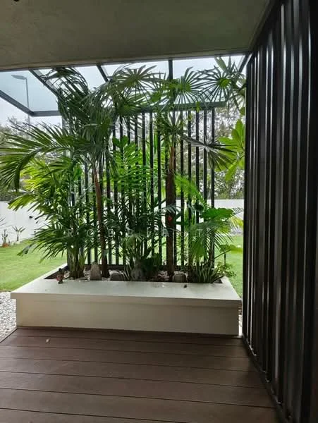 Room features: potted plants, tropical landscaping, wooden flooring, decorative stone planter, vertical slatted screen, glass roof, greenery view; style: modern; view: garden.