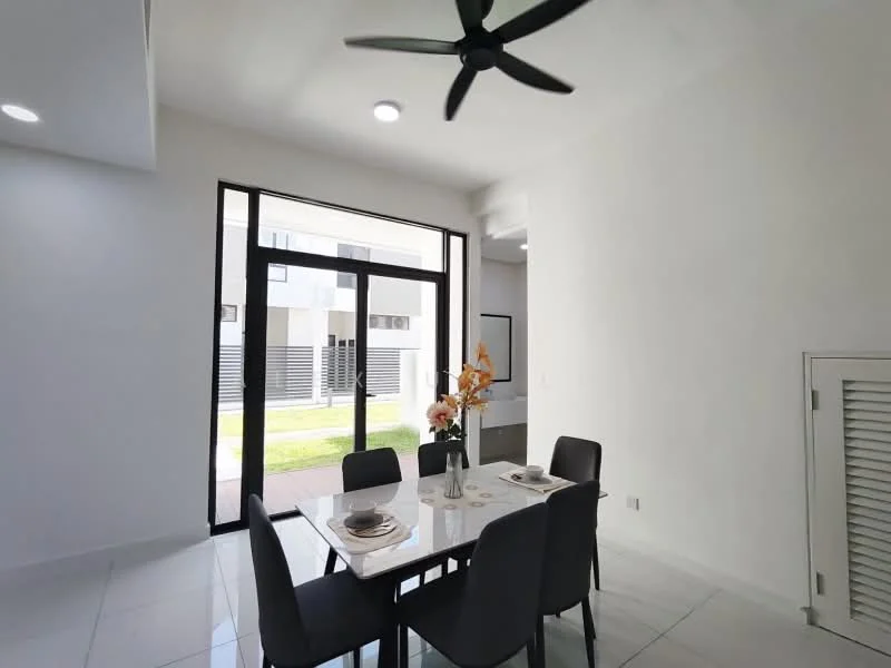 Dining features: white painted walls, glossy tile flooring, 5-blade ceiling fan with light, large glass sliding door, dining table with white surface, 4 black upholstered dining chairs, decorative vase with flowers, natural light from outside, view of garden; style: modern; view: garden.