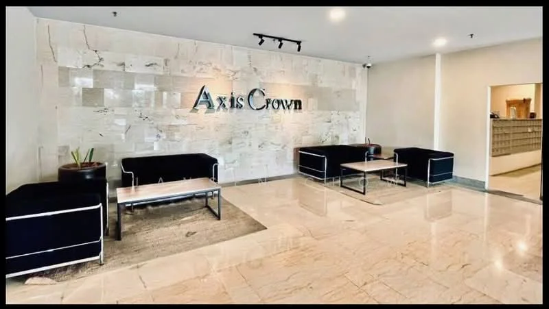 Room features: marble flooring, stone accent wall, black fabric sofas, metal coffee tables, recessed lighting, plant in ceramic pot, mailbox area visible in background, neutral wall color; style: modern.