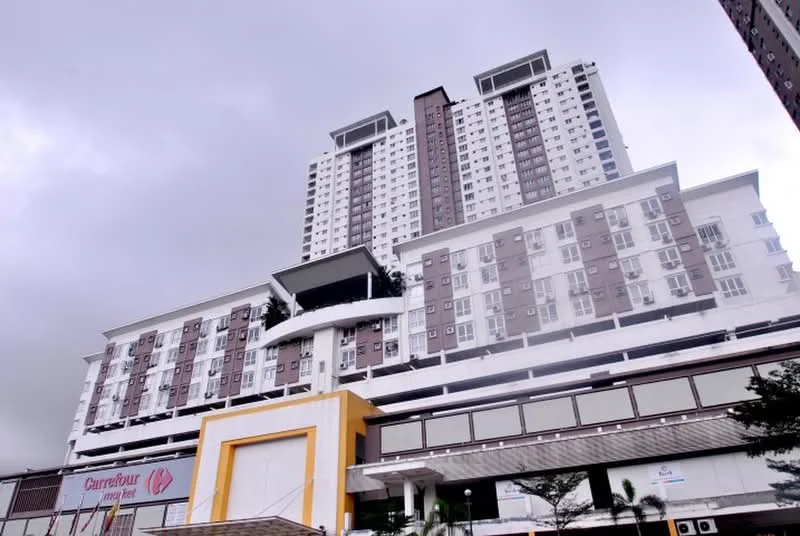 Exterior type: high-rise condominium; features: white painted facade, glass curtain wall, recessed balconies, multiple storeys, commercial space at ground level, signage for Carrefour, parking area beneath building, landscaped entrance, modern architectural design; style: modern.