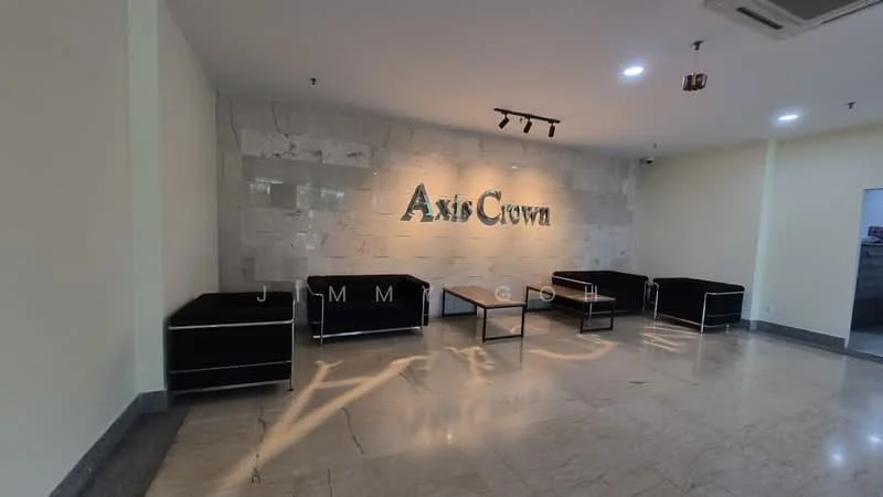 Room features: grey marble flooring, cream painted walls, feature wall with stone cladding, recessed ceiling lights, black leather sofas, glass coffee table, wall-mounted signage, air conditioning unit; style: modern.
