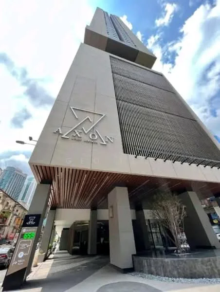 Exterior type: high-rise condominium; features: glass curtain wall, exposed concrete facade, recessed balconies, feature lighting at night, double-volume main lobby, marble flooring at entrance; style: modern.