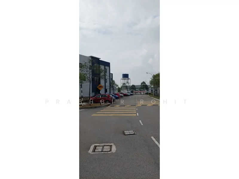 Exterior features: street view, road markings, traffic signs, water tower in background, surrounding greenery, multi-storey buildings, cars parked along the street; style: modern.