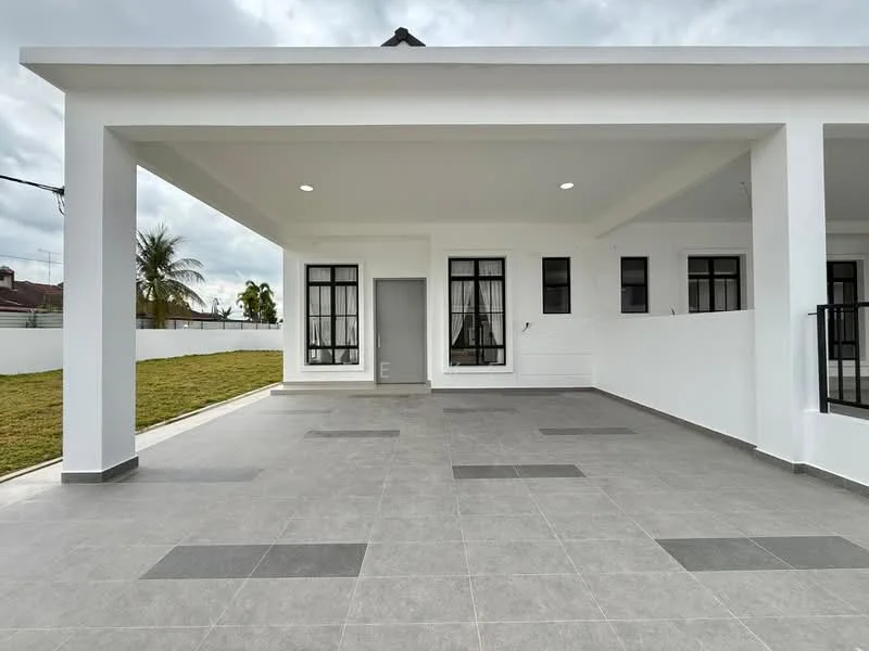 Exterior type: detached bungalow; features: white painted facade, flat roof, grey tiled flooring, large windows with black frames, covered porch area, manicured lawn, surrounded by white fencing, outdoor lighting, concrete wall, paved walkway; style: modern.
