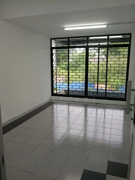 Room features: white painted walls, grey tiled flooring, large windows with black metal grilles, natural light from windows, view of greenery outside, fluorescent ceiling light, corner window, no visible furniture; style: modern; view: garden.