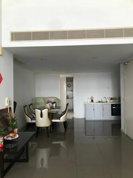 Living features: grey tiled flooring, white painted walls, dining table with six upholstered chairs, black coffee table, kitchenette with grey cabinetry, stainless-steel sink, built-in oven, microwave, recessed ceiling lights, air conditioning vent, decorative plants on coffee table; style: modern.