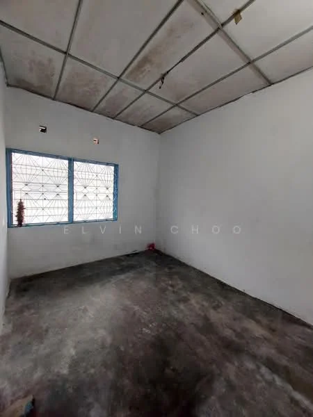 Room features: white painted walls, concrete flooring, two windows with metal grilles, exposed ceiling, no visible lighting fixtures.