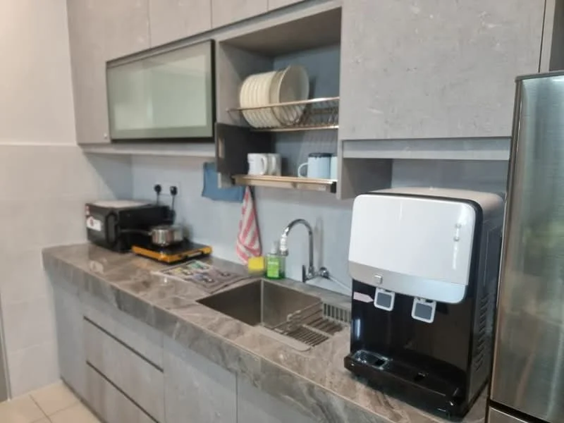 Kitchen features: grey cabinetry, marble countertop, single-bowl stainless-steel sink, chrome pull-down faucet, built-in water dispenser, microwave, coffee machine, dish rack with plates, kitchen towels, under-cabinet lighting; style: modern.