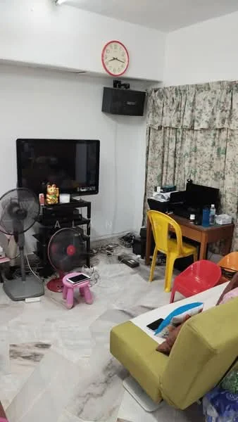 Living features: sofa in green, 3-seater sofa, coffee table, wall-mounted TV, TV console, floor fan, table with computer setup, yellow plastic chairs, decorative wall clock, curtains with floral pattern, marble flooring, cable management visible.