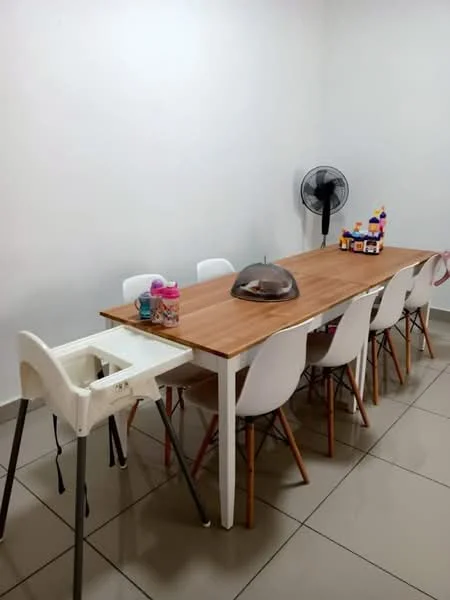 Dining features: wooden dining table with light brown finish, 8 white plastic dining chairs with wooden legs, high chair for children, ceiling fan, decorative items on table, neutral painted walls, grey tiled flooring; style: modern.
