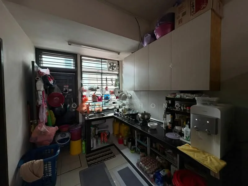 Kitchen features: white cabinetry, black countertop, stainless-steel sink, chrome faucet, built-in water dispenser, wall-mounted shelves, tile flooring, window with security bars, laundry basket, various storage containers, kitchen utensils, cooking pots, cleaning supplies.