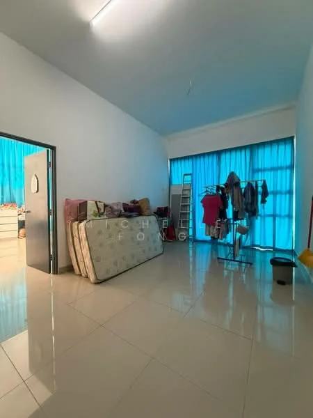 Room features: white painted walls, high ceiling, large windows with blue sheer curtains, glossy ceramic tile flooring, clothes rack, mattresses stacked against the wall, ladder, clothing hanging on rack.