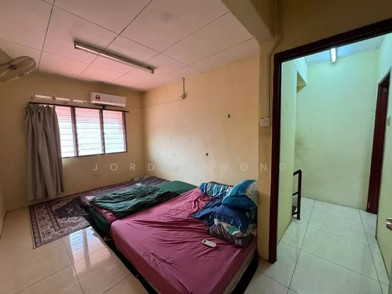 Bedroom features: queen-size bed, upholstered headboard, bedding in green and blue, 2 bedside pillows, area rug, floor-to-ceiling window, curtains, wall-mounted air conditioning unit, light fixture on ceiling, tiled flooring, cream painted walls. Room features: doorway leading to another room, light fixture on ceiling, cream painted walls, tiled flooring.