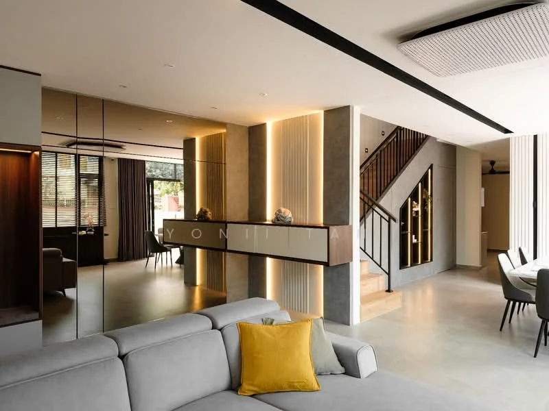 Living features: grey fabric sofa, yellow accent pillow, recessed LED downlights, wooden flooring, decorative wall paneling, floor-to-ceiling windows, curtains, open layout, mirrored wall, staircase with wooden steps, dining area visible, modern lighting fixtures; style: modern. Dining features: dining table, upholstered dining chairs, decorative centerpiece, open layout, visible from living area; style: modern.