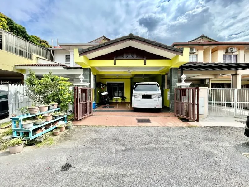 Exterior type: linked terrace house; features: yellow painted facade, pitched tile roof, front porch with driveway, white van parked in driveway, manicured garden with potted plants, wooden gate, brick paving on driveway, surrounded by residential buildings, covered car porch, security gate; style: modern.