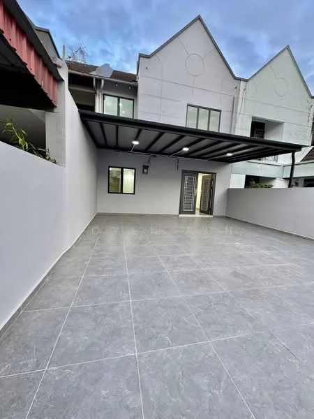 Exterior type: linked terrace house; features: grey tiled flooring, flat roof with overhang, white painted walls, glass sliding door, outdoor space with no landscaping, modern architectural design, two-storey building in background, security light fixture, fenced perimeter; style: modern.