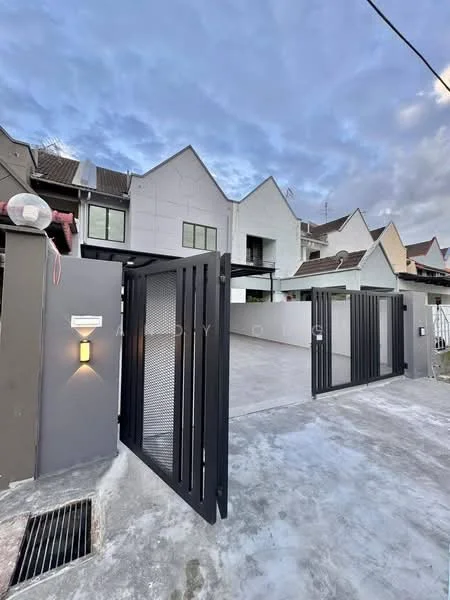 Exterior type: linked terrace house; features: black metal gate, grey painted facade, two-storey structure, sloped roof, concrete driveway, manicured lawn, surrounding residential buildings, outdoor lighting fixture, paved walkway, fence surrounding property; style: modern.