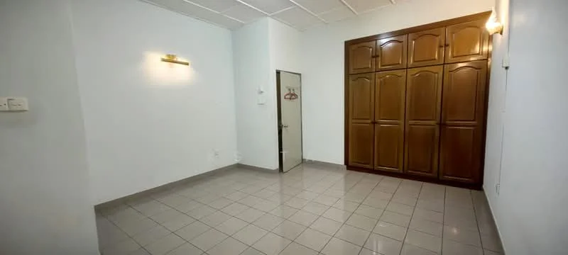 Room features: white painted walls, grey tiled flooring, built-in wooden wardrobe with multiple doors, single door, wall-mounted light fixture, no visible window treatments, minimal decor; style: minimalist.