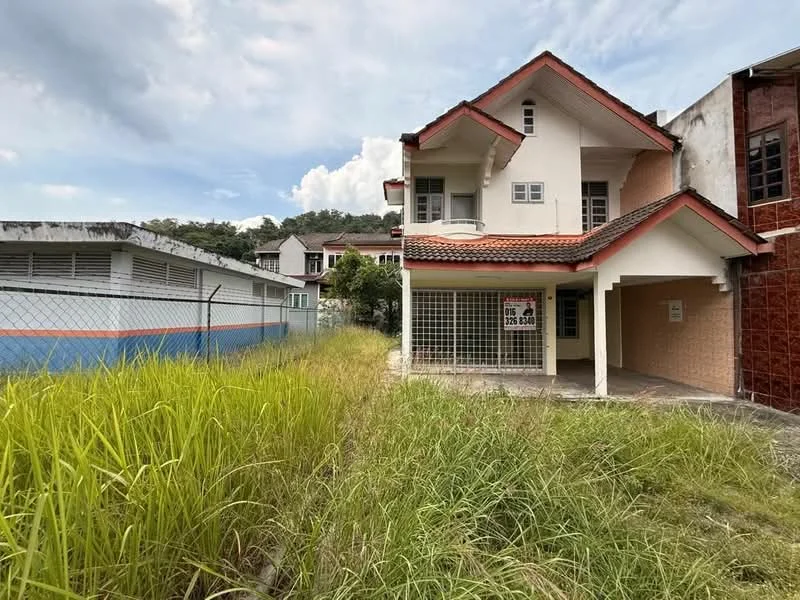 Exterior type: semi-detached house; features: two-storey structure, red tiled roof, white painted facade, large windows, front porch, fenced yard, overgrown grass, surrounding greenery, adjacent buildings, sidewalk, driveway; style: modern.